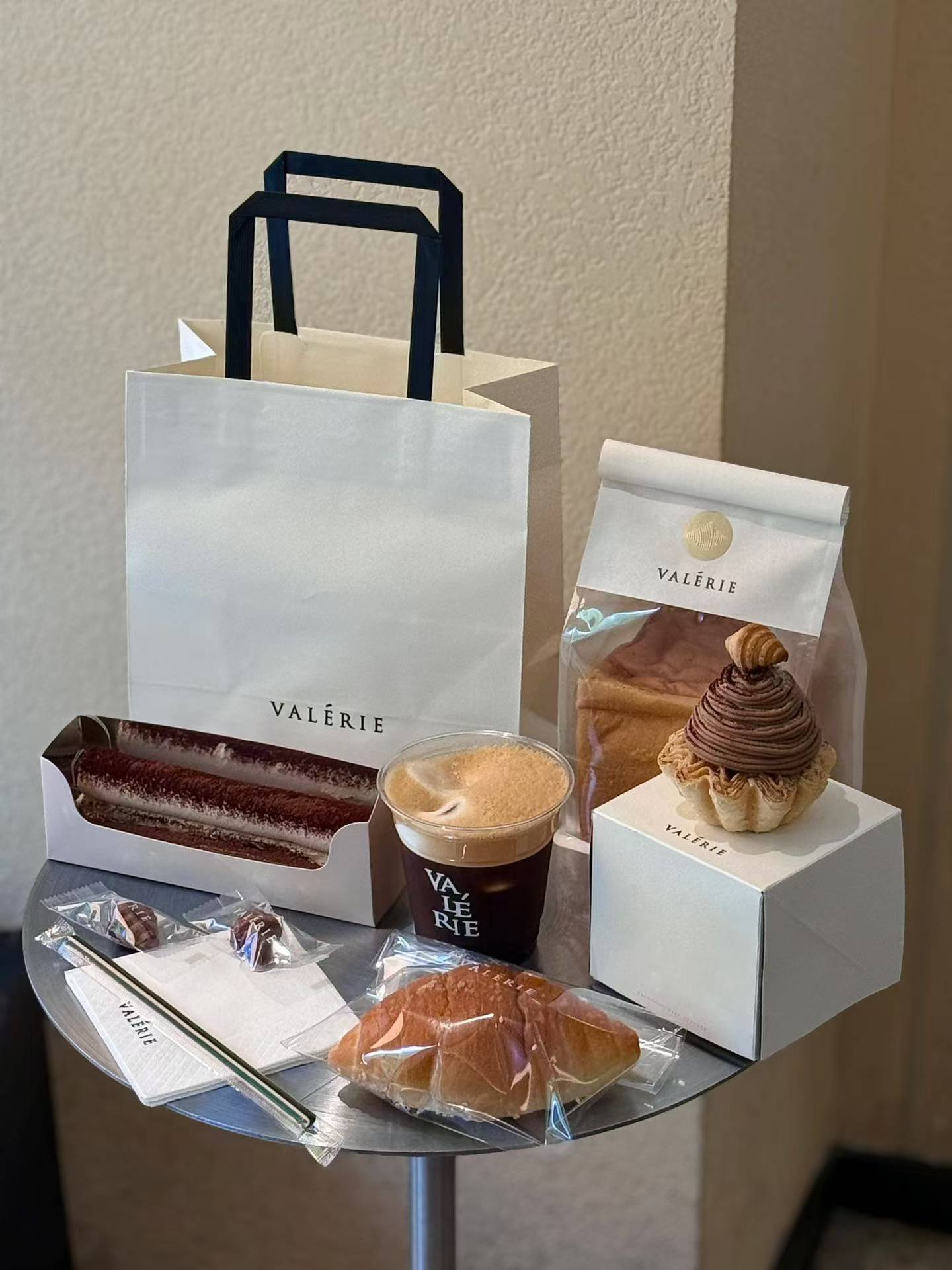 Reference packaging set showing paper bags, cups, pastry boxes, napkins and food wraps in one coordinated cafe identity.