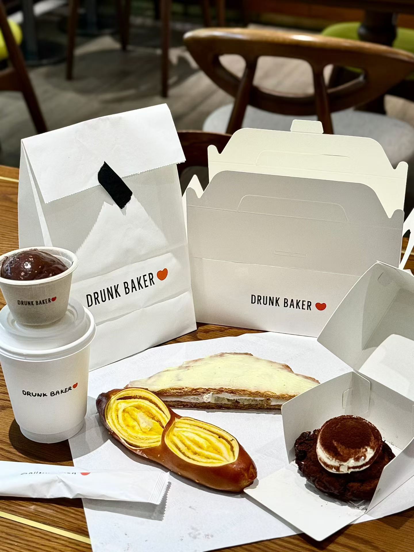 Reference photo showing branded bakery and cafe packaging formats.