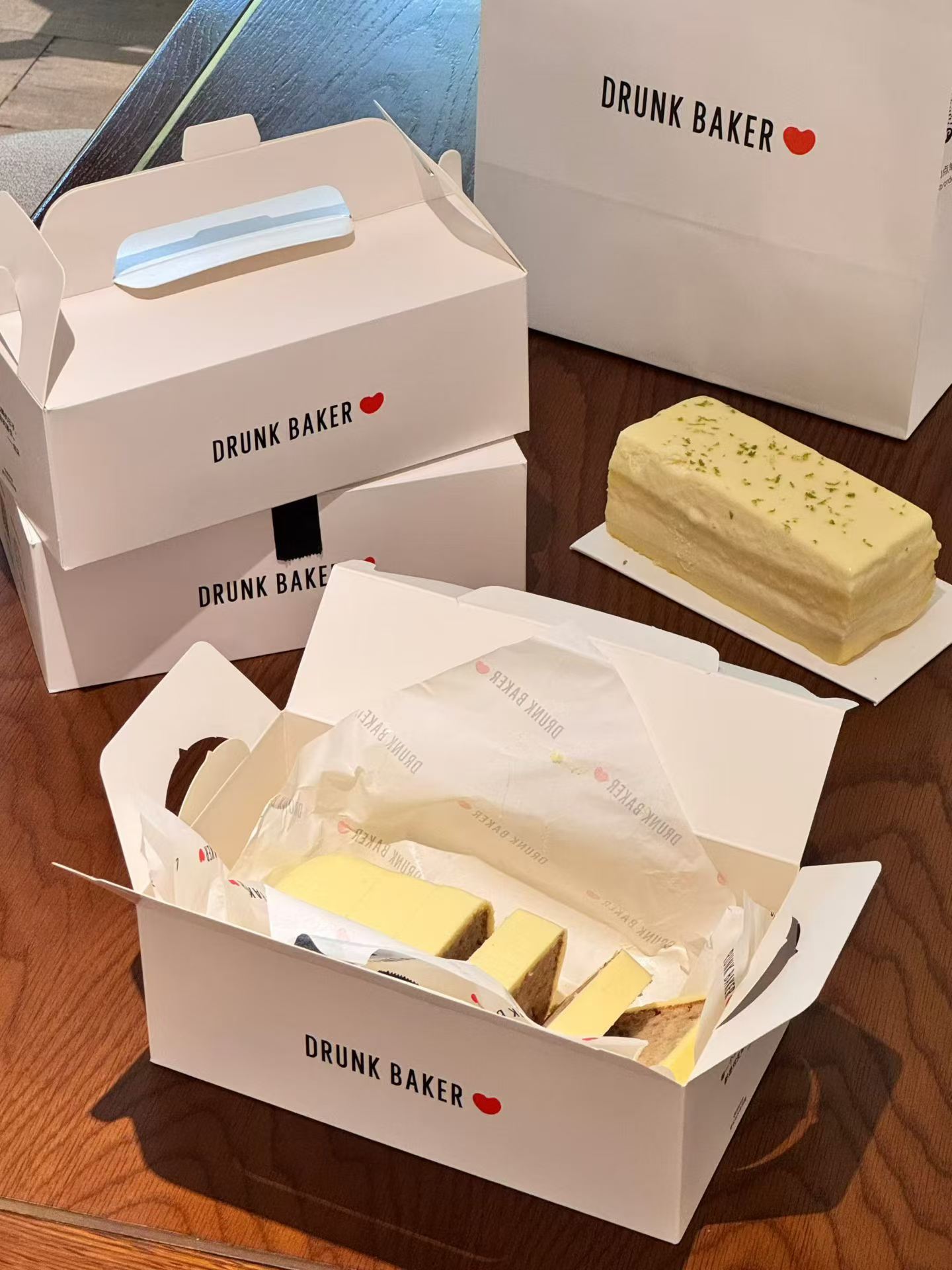 Reference photo showing branded bakery and cafe packaging formats.
