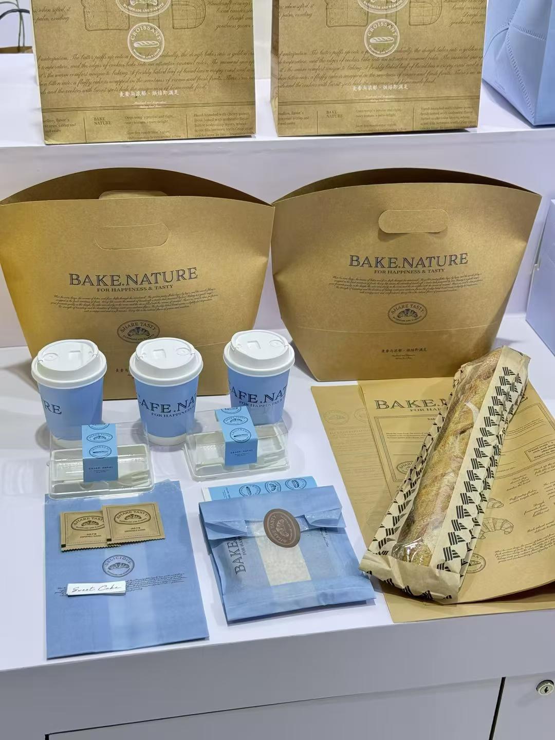 Reference photo showing a kraft and blue cafe packaging set.